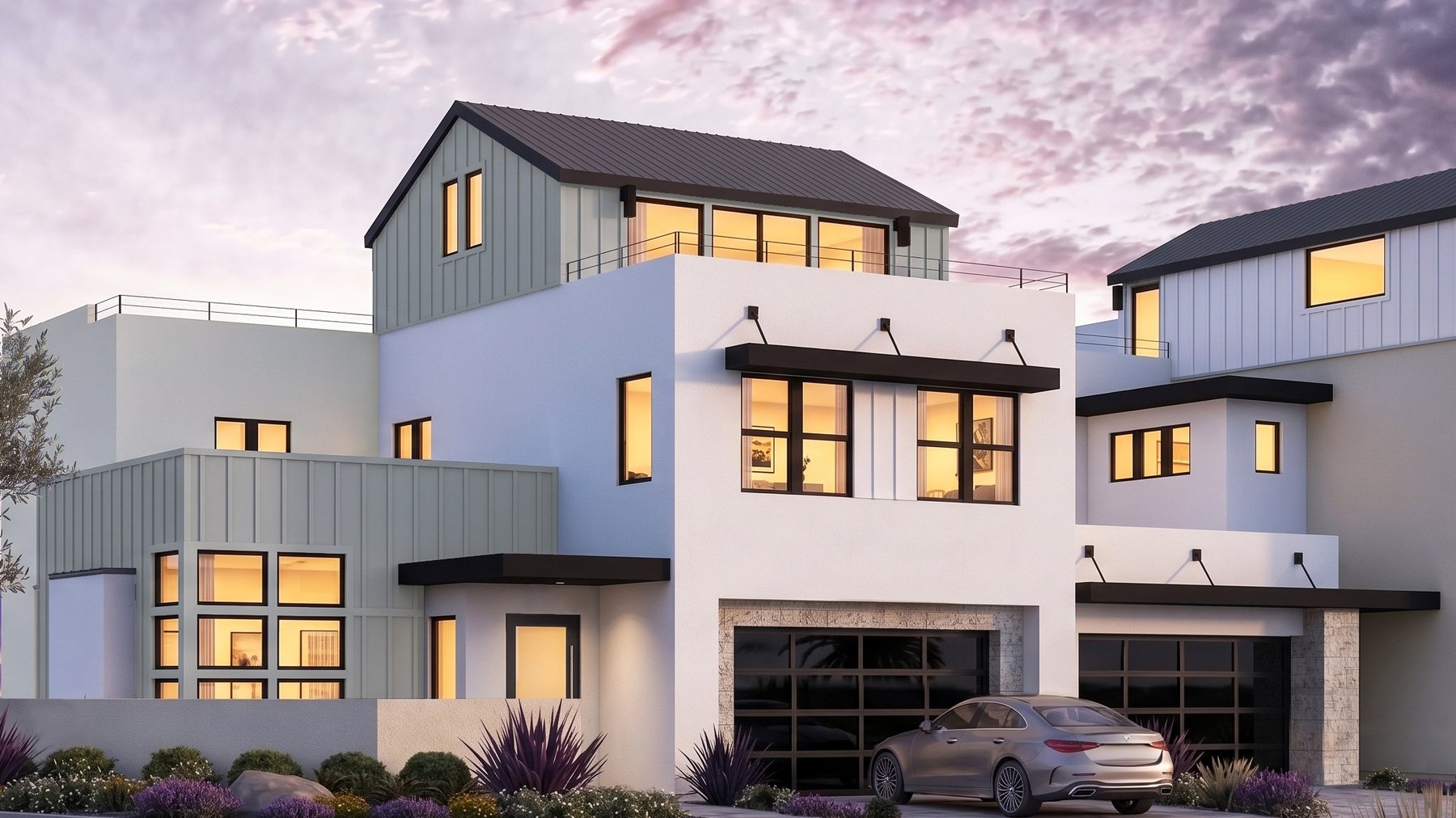 Residence 2 at Rocky Ridge at dusk. Color scheme 5, with sage board and batten siding, a standing seam gable above the roof deck and a glass-paneled two-car garage.