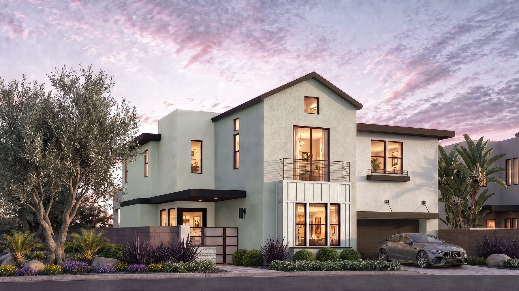 Residence 5 at Rocky Ridge at dusk. Elevation B, gable roof line, color scheme 1, with a tall gable over the two-story foyer and a second-floor balcony.