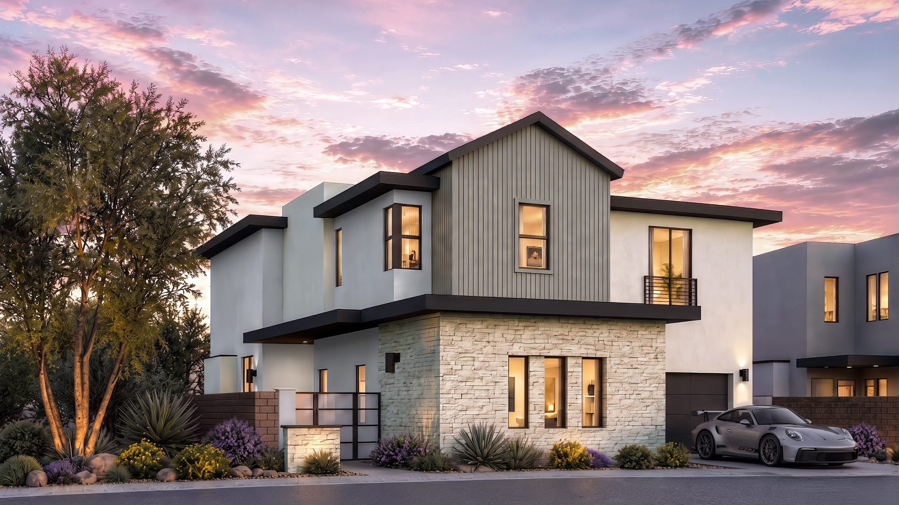 Residence 8 at Rocky Ridge at dusk. Elevation B, gable roof line, color scheme 4, with a stacked stone base and a flat roof wing.